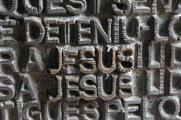 Jesus Word and Others Words Background on Sagrada Familia Door, Barcelona, Spain