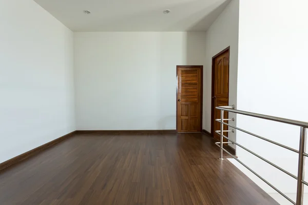 Empty room, white mortar wall background and wood laminate floor