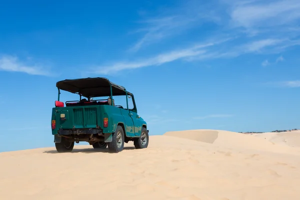 Off road car vehicle in white sand dune desert at Mui Ne