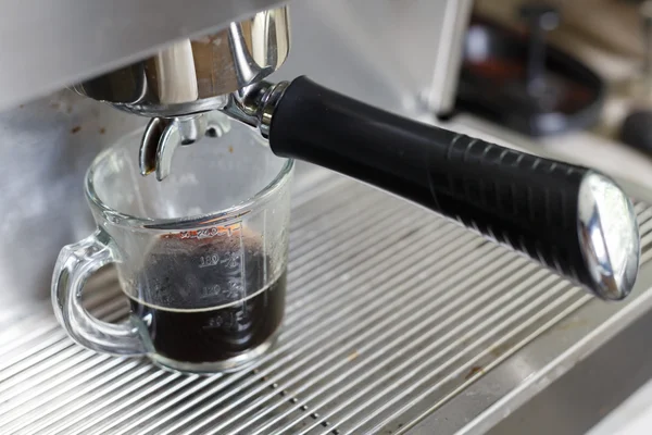 Coffee making process from coffee machine in cafe shop