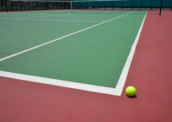 Tennis ball on green court