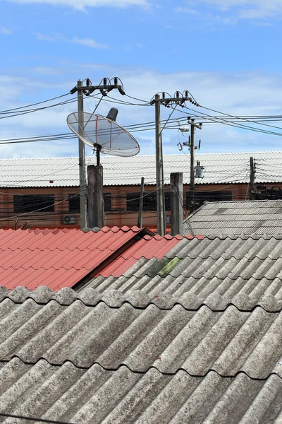 Satellite dish and TV antennas on the house roof with electricit
