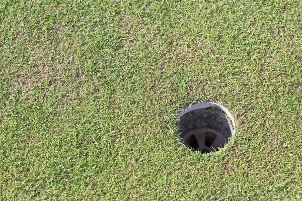 Golf hole on green grass, golf course