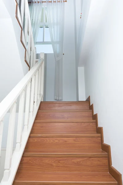 Wooden staircase made from laminate wood in white modern house