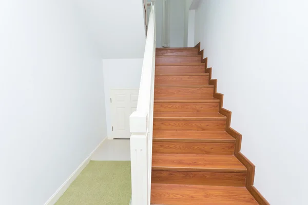 Wooden staircase made from laminate wood in white modern house