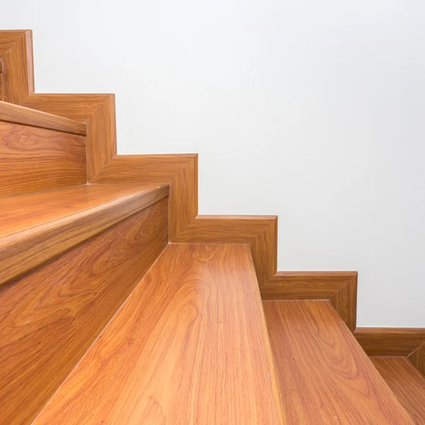 Wooden staircase made from laminate wood in white modern house