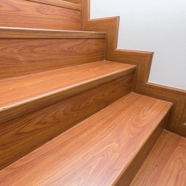 Wooden staircase made from laminate wood in white modern house