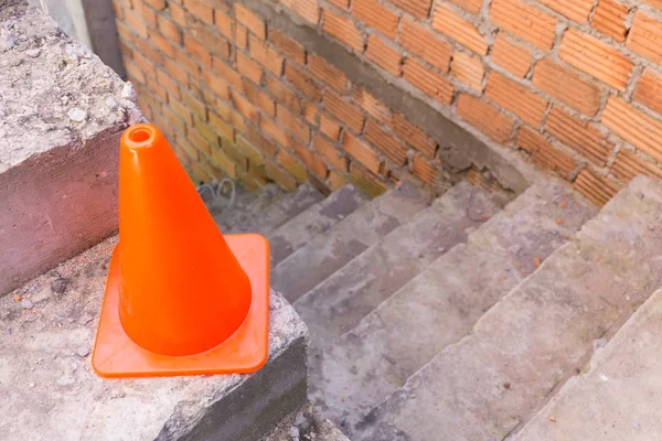Construction cone in construction site with bricks
