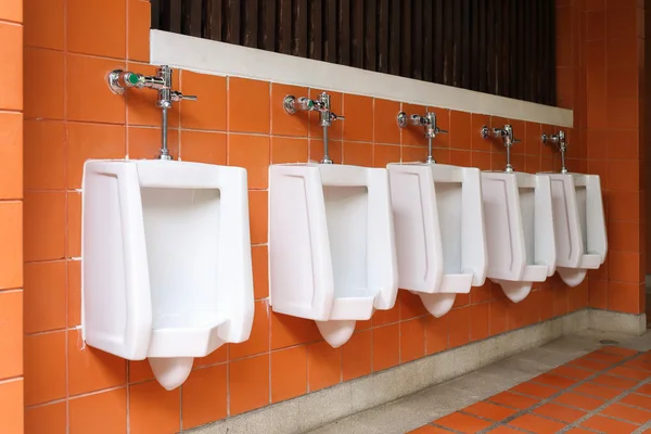 Decor interior of white urinals in men bathroom toilet