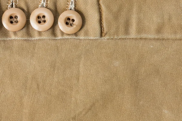 Design botton of brown shirt on fabric textile background