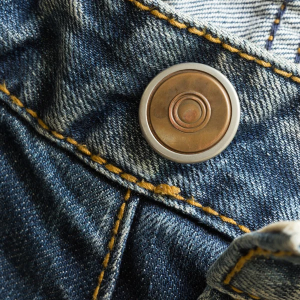 Metal botton on fashion blue jeans