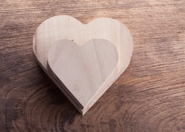 Heart brown wood box on wood background, abstract love