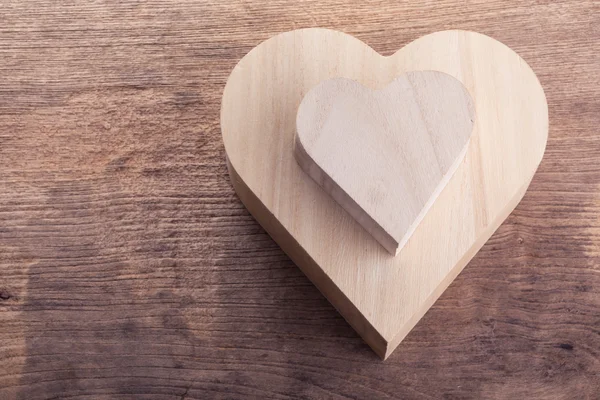 Heart brown wood box on wood background, abstract love