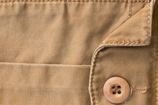 Front pocket on brown shirt textile texture background