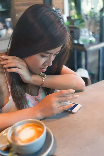 Women lifestyle using a mobile phone in cafe coffee shop