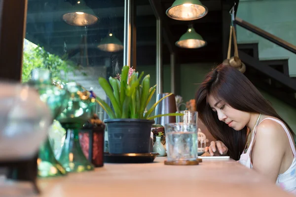 Women lifestyle using a mobile phone in cafe coffee shop