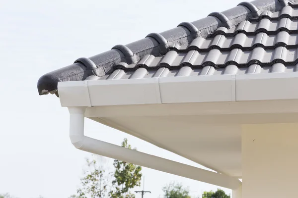 White gutter on the roof top of house