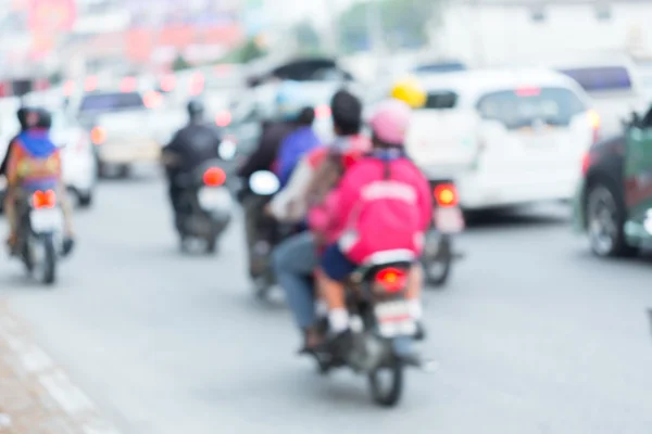 Car and motorcycle driving on road with traffic jam in the city