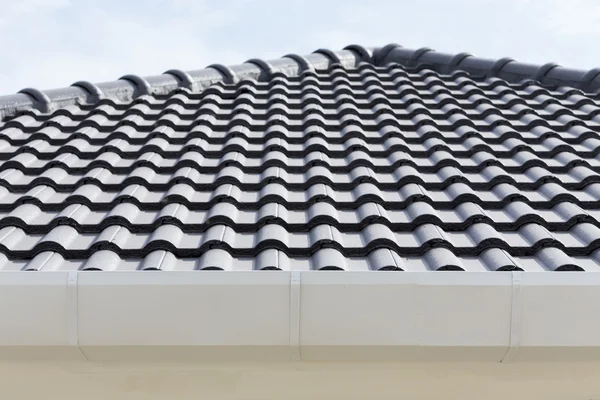 White gutter on the roof top of house
