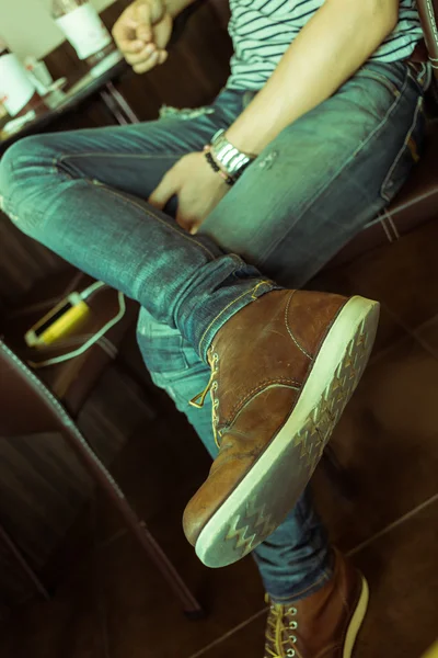 Brown boot leather shoes and jean pants clothing fashion of man