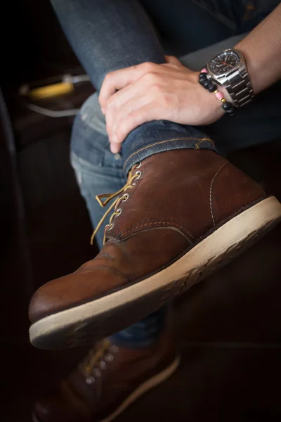 Brown boot leather shoes and jean pants clothing fashion of man