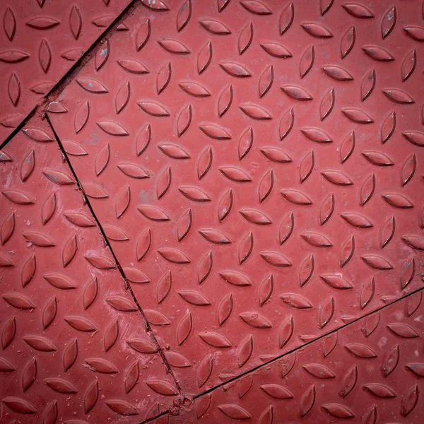 Red dirty metal plate, metallic grunge texture background