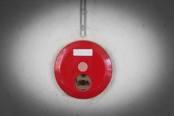 Red fire alarm box for warning security system mounted on wall