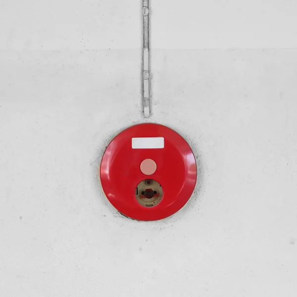 Red fire alarm box for warning security system mounted on wall