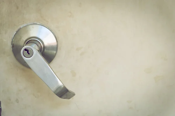 Metallic steel knob door handle lock the old white door