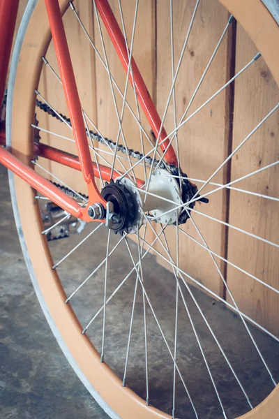 Fixed gear bicycle parked with wood wall, close up image