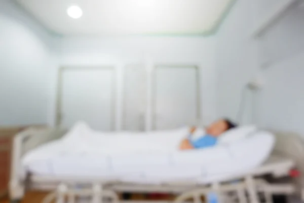 Patient sleep on bed, image blur hospital background