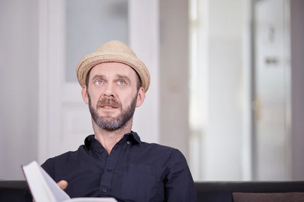 White male man with book looking up copyspace