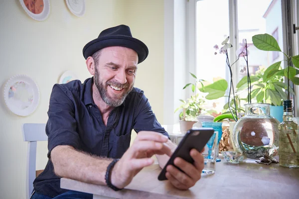 Hipster looking at phone to camera happy laughing
