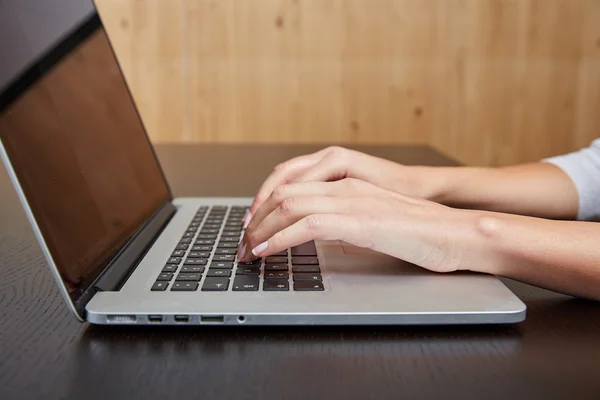 Woman typing on a laptop computer