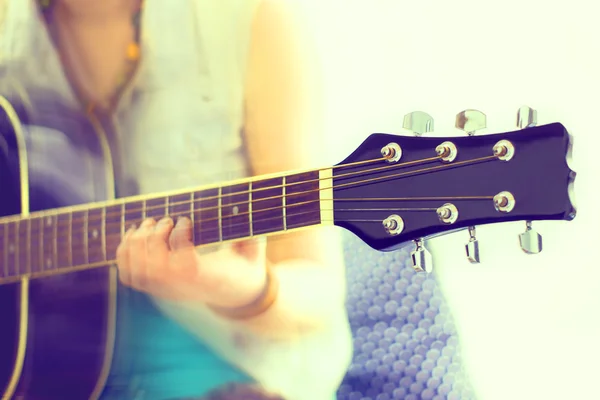 Close up shot of strings and guitarist hands playing guitar