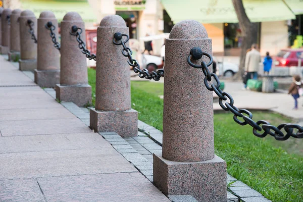 Stone column fence with metal chain