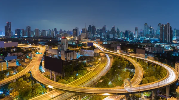 Twilight city highway aerial view with city downtown background, Bangkok Thailand