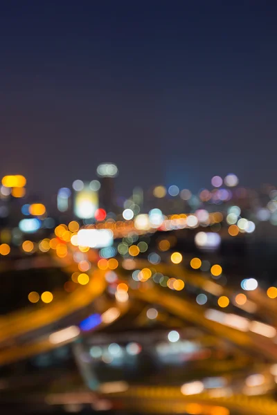 Night view, abstract blurred bokeh lights highway interchanged and city downtown