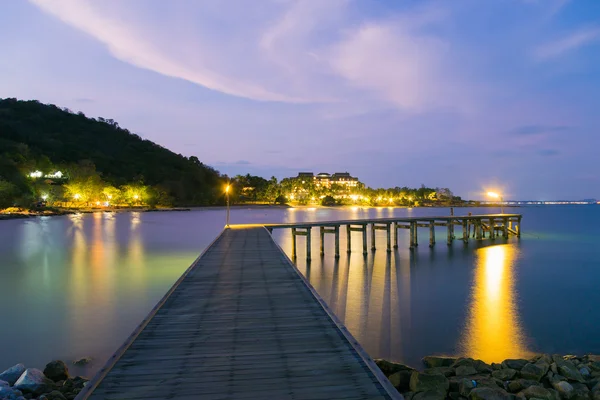 Wooden bridge walkway leading to the sea night view