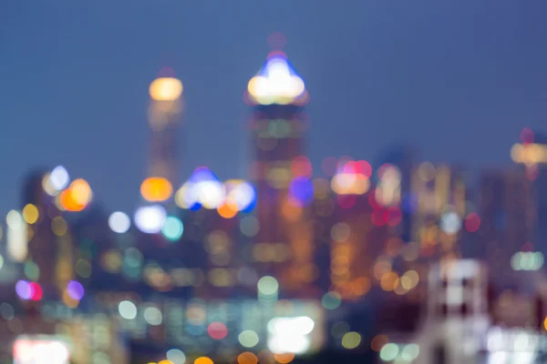 Blurred multiple colour lights night view, city office building background