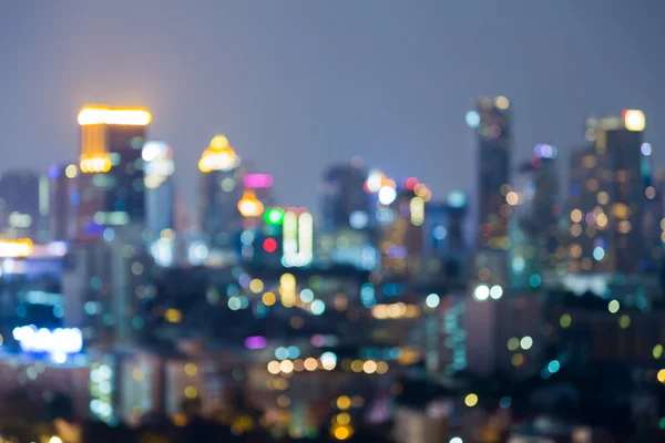 Blurred bokeh lights city office building night background