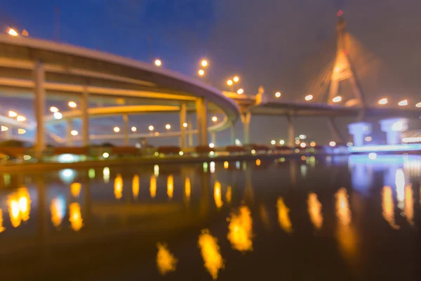 Abstract blurred bokeh light, suspension bridge with highway intersection