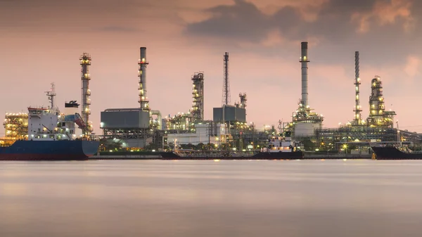 Oil refinery along the river during sunrise