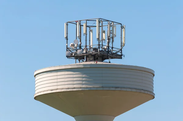 Water tank tower surmounted with a telephone repeater antennas