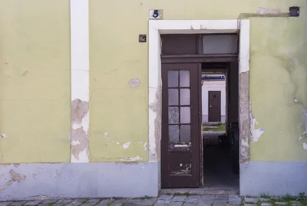 Opened door to the yard of an old house