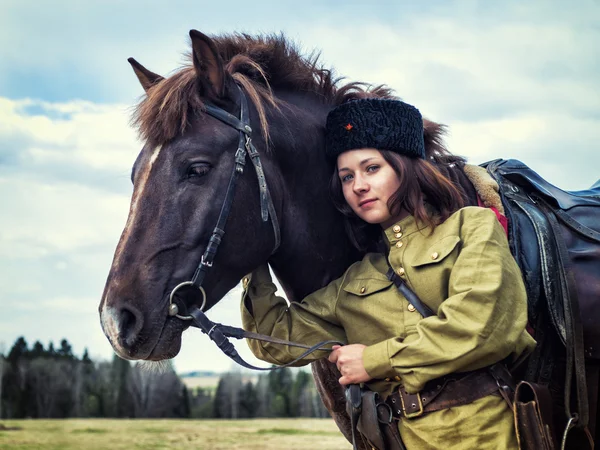 Girl warrior Cossack with a horse. Portrait.