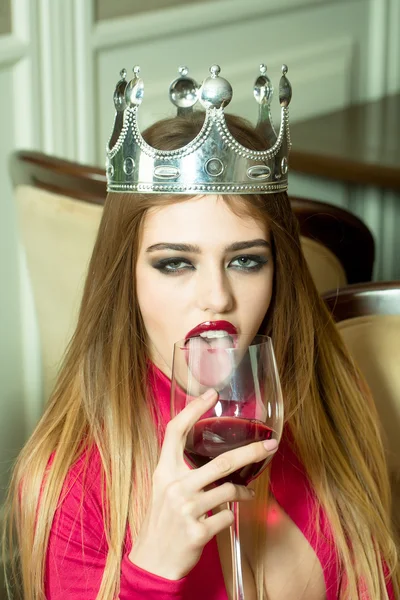 Woman in crown with wine