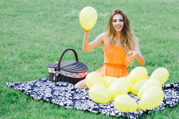 Woman on picnic with balloons