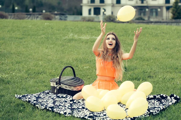 Woman on picnic with balloons