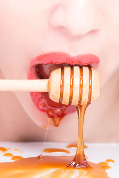 Female lips with honey